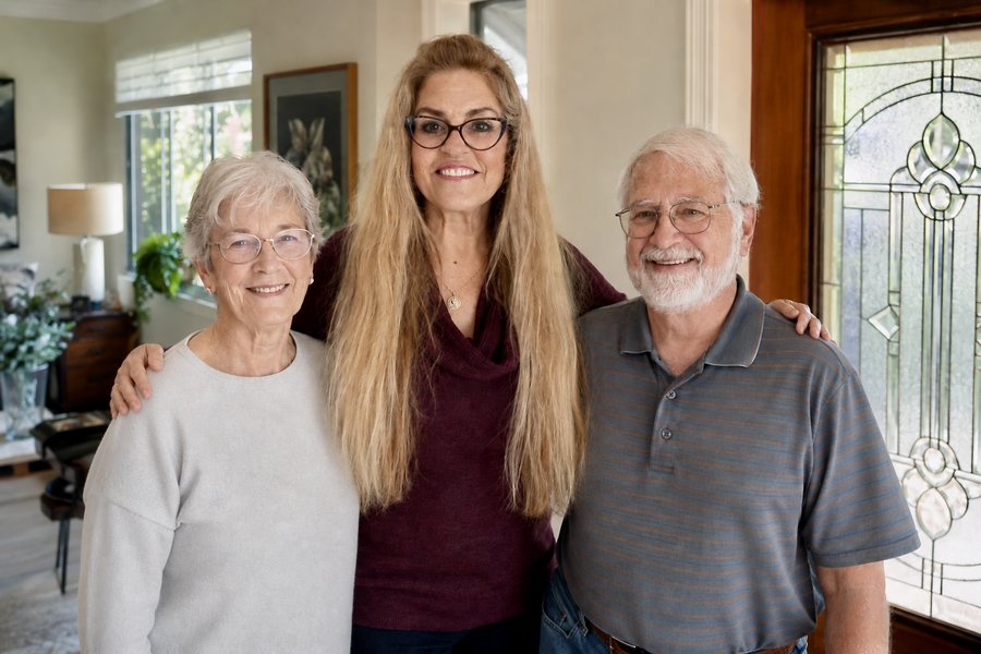 Kathlene Carney Seidel with two smiling clients at their home