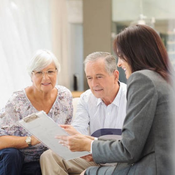 Kathlene Carney Seidel with two smiling clients at their home